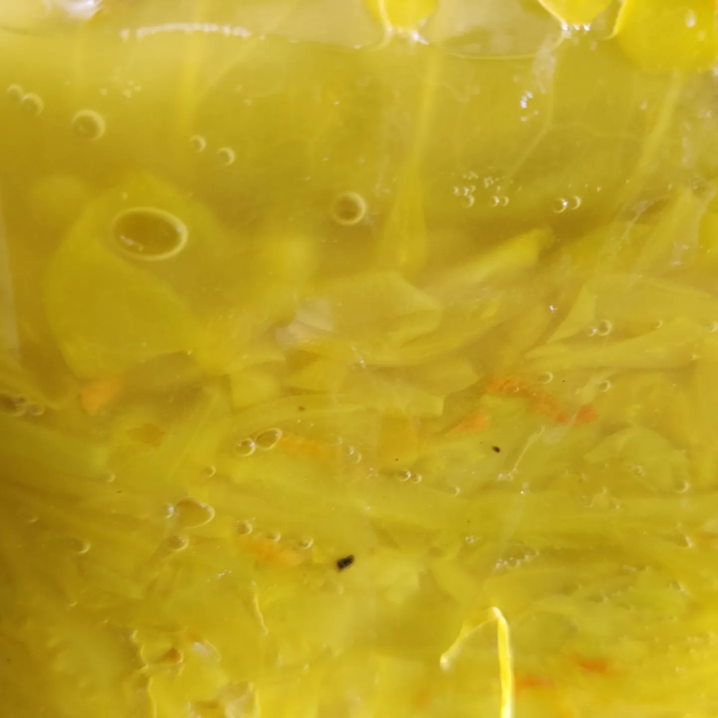 zoomed in fermentation jar with yellow cabbage